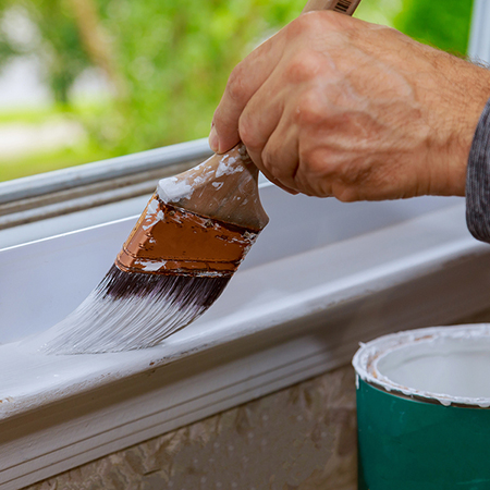Painter brushing trim